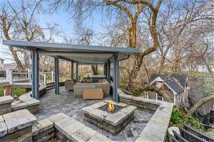 View of terrace with a deck and an outdoor living space with a fire pit