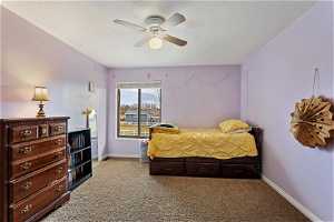 Bedroom with light colored carpet and ceiling fan