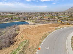 Birds eye view of property with a water view