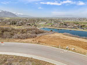 Drone / aerial view featuring a water and mountain view