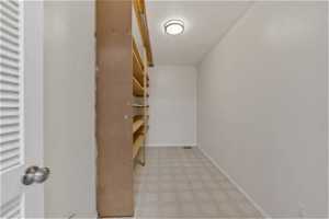 Large pantry with light tile flooring