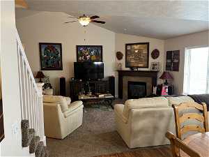 VIEW OF GREAT ROOM WITH FIREPLACE AND VAULTER CEILINGS  WITH STAIRS TO BONUS ROOM.