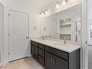 Bathroom with tile floors, double sink, and large vanity
