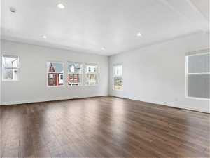 Unfurnished room featuring dark hardwood / wood-style flooring and a wealth of natural light