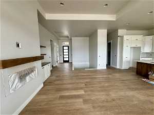 Interior space featuring white cabinets and light hardwood / wood-style floors