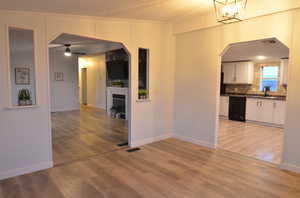 Den with a textured ceiling, LVP flooring, and crown molding