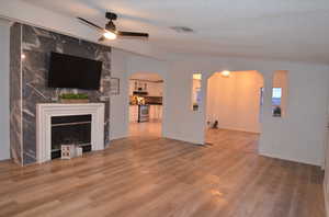 Living room featuring a textured ceiling, LVP flooring, and ceiling fan