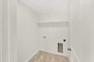 Washroom with washer hookup, light tile flooring, and electric dryer hookup