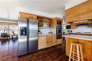 Kitchen featuring stainless steel appliances and a breakfast bar