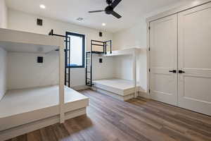 Unfurnished bedroom with a closet, ceiling fan, and hardwood / wood-style floors