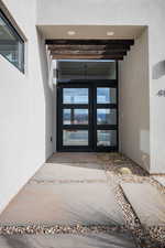 Property entrance featuring french doors