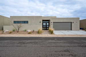 Southwest-style home featuring a garage