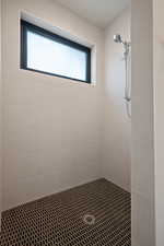 Bathroom with a tile shower and a wealth of natural light