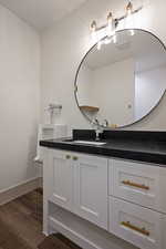 Bathroom with hardwood / wood-style flooring and vanity