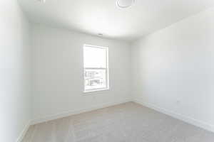 Unfurnished room with carpet