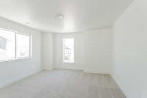 Empty room with light colored carpet