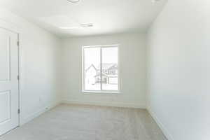 Carpeted empty room featuring a textured ceiling