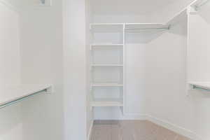 Walk in closet with carpet flooring