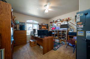 Carpeted home office with ceiling fan