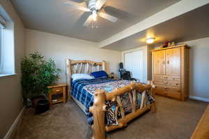 Carpeted bedroom with a closet and ceiling fan