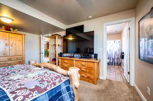 Bedroom featuring a textured ceiling and light carpet