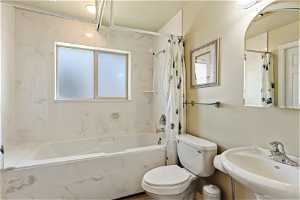 Main bathroom with oversized soaker tub, and pedestal sink