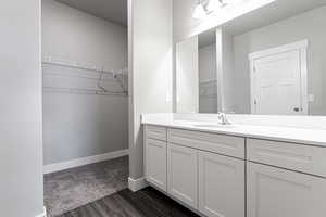 Bathroom with vanity and hardwood / wood-style floors