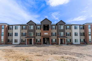 View of building exterior featuring cooling unit