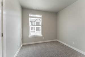 Unfurnished room with carpet flooring