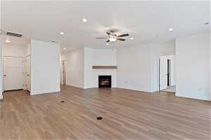 Unfurnished living room with light hardwood / wood-style flooring and ceiling fan