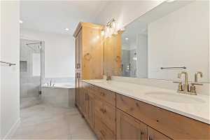 Bathroom with shower with separate bathtub, dual vanity, and tile flooring