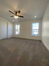 Carpeted spare room with ceiling fan and a textured ceiling. Pictures are for reference only of the MAINE floor plan. Actual finishes may vary.