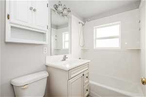 Full bathroom featuring shower / bathing tub combination, vanity, and toilet