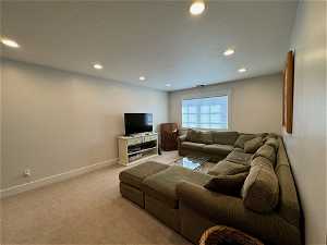 upper family room featuring light colored carpet