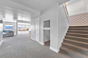 Staircase with light colored carpet