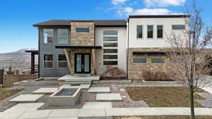 View of front of home with a mountain view and french doors