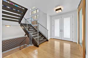 Entryway with french doors and light wood-type flooring