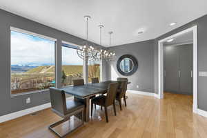 Dining room with a notable chandelier and light wood-type flooring