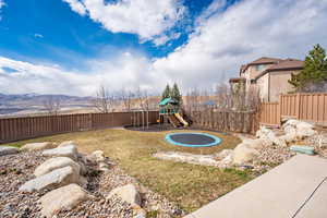 View of yard with a mountain view and a playground