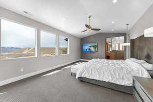 Bedroom with dark carpet, lofted ceiling, and ceiling fan