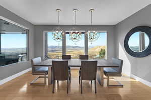 Dining area with light wood-type flooring and a chandelier