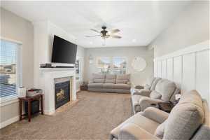 Carpeted living room featuring plenty of natural light and ceiling fan