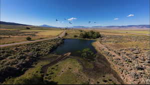 Aerial view with a rural view and a water and mountain view