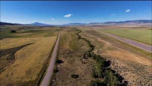 Birds eye view of property with a mountain view and a rural view