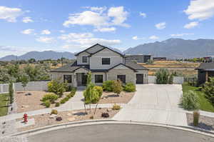 View of front of home featuring a mountain view and a garage