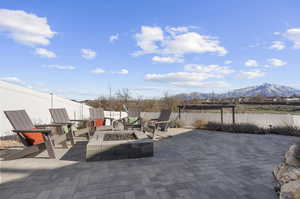 View of patio / terrace featuring a mountain view and an outdoor fire pit