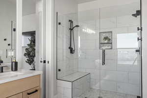 Bathroom with an enclosed shower and vanity