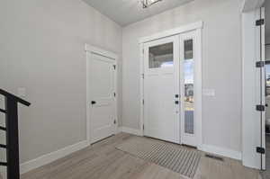 Foyer entrance with light hardwood / wood-style flooring