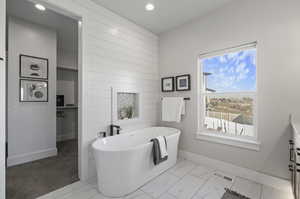 Bathroom featuring tile flooring and a washtub