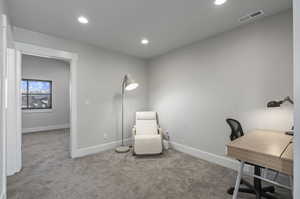 Home office featuring light colored carpet